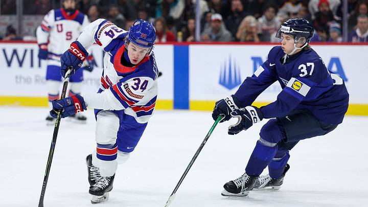 Jan 2, 2026; St. Paul, Minnesota, UNITED STATES; United States forward Cole Eiserman (34) and Finland forward Matias Vanhanen (37) compete for the puck during the first period in the quarterfinals of the 2026 IIHF World Junior Championship at Grand Casino Arena. Mandatory Credit: Matt Krohn-Imagn Images