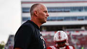 Aug 28, 2025; Raleigh, North Carolina, USA; North Carolina State Wolfpack head coach Dave Doeren looks on during the warmups prior to the game against East Carolina Pirates at Carter-Finley Stadium. Mandatory Credit: Jaylynn Nash-Imagn Images