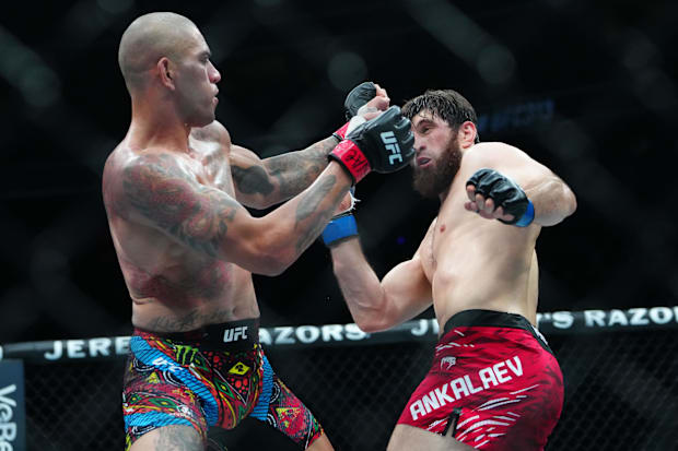 Alex Pereira (red gloves) fights Magomed Ankalaev (blue gloves) during UFC 313 at T-Mobile Arena.