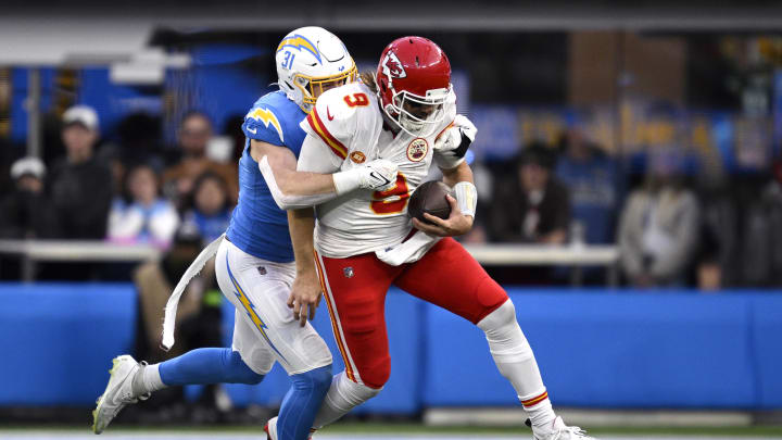 Jan 7, 2024; Inglewood, California, USA; Kansas City Chiefs quarterback Blaine Gabbert (9) is tackled by Los Angeles Chargers linebacker Nick Niemann (31) during the second half at SoFi Stadium. Mandatory Credit: Orlando Ramirez-USA TODAY Sports