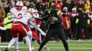 Nov 29, 2024; Iowa City, Iowa, USA; Iowa Hawkeyes running back Kaleb Johnson (2) runs the ball as Nebraska Cornhuskers defensive back DeShon Singleton (8) looks to make the tackle during the third quarter at Kinnick Stadium. Mandatory Credit: Jeffrey Becker-Imagn Images
