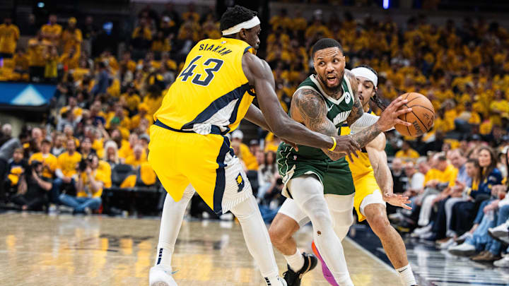 Milwaukee Bucks guard Damian Lillard (0) looks to pass the ball while  Indiana Pacers forward Pascal Siakam (43) and guard Andrew Nembhard (2) defend during game three of the first round for the 2024 NBA playoffs at Gainbridge Fieldhouse. 