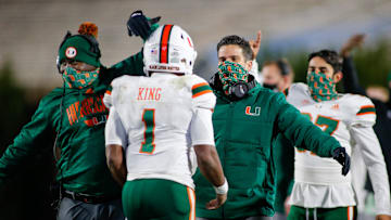 Dec 5, 2020; Durham, North Carolina, USA;  Miami Hurricanes head coach Manny Diaz, right, congratulates Miami Hurricanes quarterback D'Eriq King (1) after a touchdown drive against the Duke Blue Devils in the third quarter at Wallace Wade Stadium. The Miami Hurricanes won 48-0. Mandatory Credit: Nell Redmond-Imagn Images