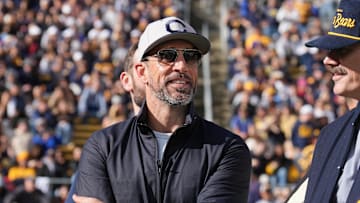 Nov 23, 2024; Berkeley, California, USA; California Golden Bears former quarterback Aaron Rodgers stands on the field before the start of the second quarter against the Stanford Cardinal at California Memorial Stadium. Mandatory Credit: Darren Yamashita-Imagn Images