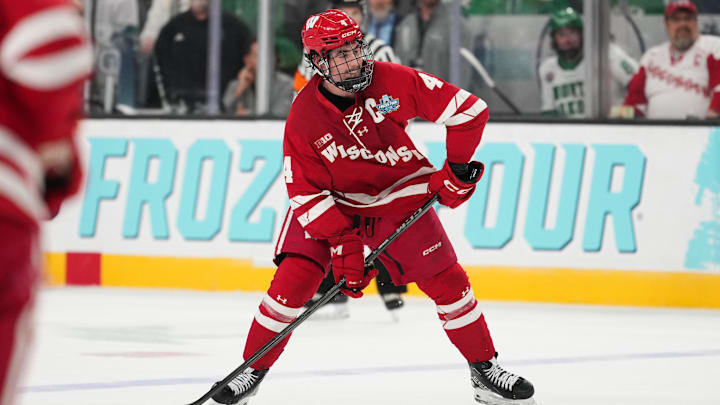 Apr 9, 2026; Las Vegas, Nevada, UNITED STATES; Wisconsin Badgers defenseman Ben Dexheimer (4) looks to shoot in the first period against the North Dakota Fighting Hawks in the semifinals of the NCAA men's ice hockey Frozen Four at T-Mobile Arena. Mandatory Credit: Lucas Peltier-Imagn Images
