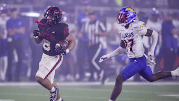 Oct 11, 2025; Lubbock, Texas, USA;  Texas Tech Red Raiders running back Cameron Dickey (8) rushes for a touchdown against Kansas Jayhawks defensive safety Taylor Davis (27) in the second half at Jones AT&T Stadium. Mandatory Credit: Michael C. Johnson-Imagn Images