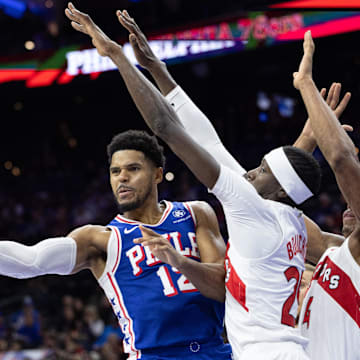 Nov 2, 2023; Philadelphia, Pennsylvania, USA; Philadelphia 76ers forward Tobias Harris (12) passes the ball past Toronto Raptors forward Chris Boucher (25) during the second quarter at Wells Fargo Center. Mandatory Credit: Bill Streicher-USA TODAY Sports