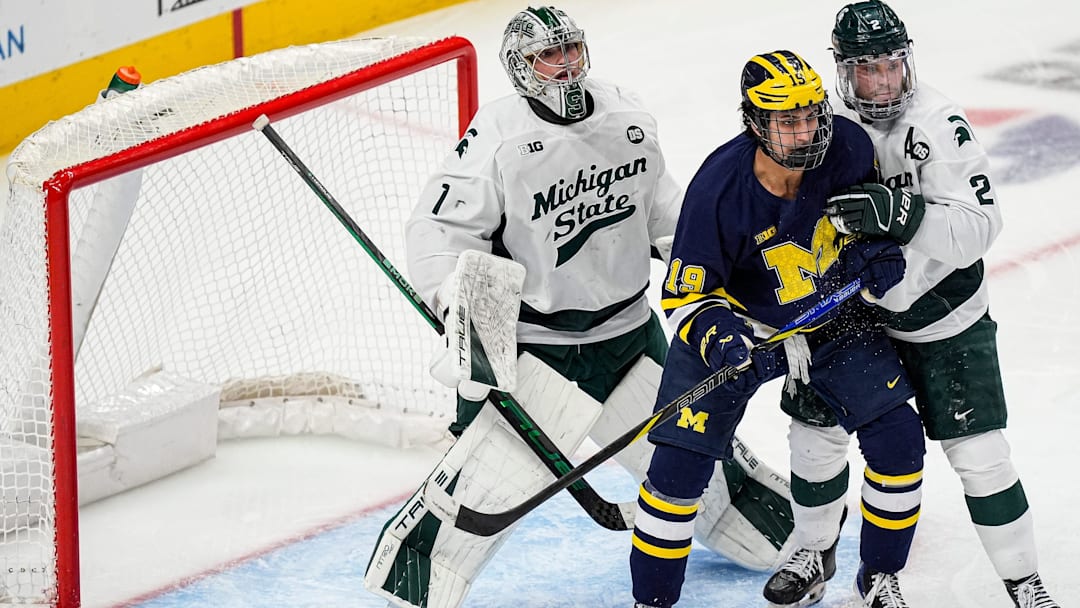 Michigan State goaltender Trey Augustine (1), left, tends net against Michigan forward Michael Hage (19) during the second period of Duel in the D at Little Caesars Arena in Detroit on Saturday, February 7, 2026.