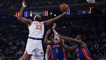 Nov 30, 2023; New York, New York, USA; New York Knicks center Mitchell Robinson (23) rebounds after the game Detroit Pistons guard Cade Cunningham (2): Vincent Carchietta-Imagn Images