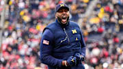 Michigan head coach Sherrone Moore cheer on as he runs onto the filed for warmup at Michigan Stadium in Ann Arbor on Saturday, Nov. 29, 2025.