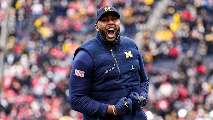 Michigan head coach Sherrone Moore cheer on as he runs onto the filed for warmup at Michigan Stadium in Ann Arbor on Saturday, Nov. 29, 2025.