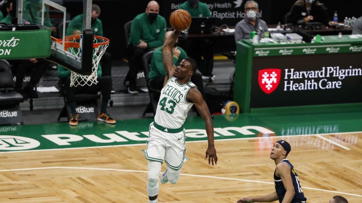 Feb 16, 2021; Boston, Massachusetts, USA; Boston Celtics guard Javonte Green (43) dunks against Denver Nuggets guard R.J. Hampton (13) during the second quarter at TD Garden. Mandatory Credit: Winslow Townson-USA TODAY Sports