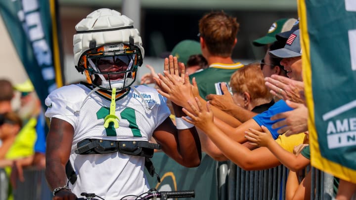 Green Bay Packers wide receiver Jayden Reed slaps hands with fans at training camp on Wednesday.