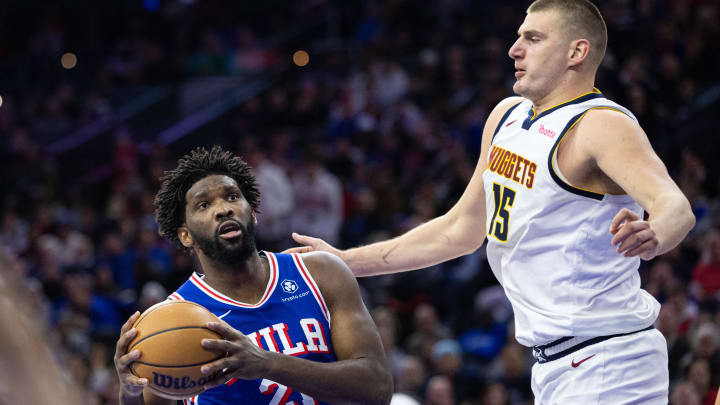 Jan 16, 2024; Philadelphia, Pennsylvania, USA; Philadelphia 76ers center Joel Embiid (21) drives against Denver Nuggets center Nikola Jokic (15) during the fourth quarter at Wells Fargo Center. Mandatory Credit: Bill Streicher-USA TODAY Sports