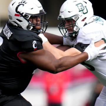 Oct 21, 2023; Cincinnati, Ohio, USA; Cincinnati Bearcats defensive lineman Dontay Corleone (2) rushes against Baylor Bears offensive lineman Campbell Barrington (53) in the first quarter at Nippert Stadium. Mandatory Credit: Kareem Elgazzar-USA TODAY Sports