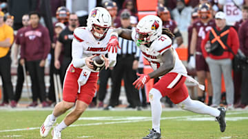 Nov 1, 2025; Blacksburg, Virginia, USA; Louisville Cardinals quarterback Miller Moss (7) hands the ball off to Louisville Cardinals running back Keyjuan Brown (22) during the fourth quarter at Lane Stadium. Mandatory Credit: Brian Bishop-Imagn Images
