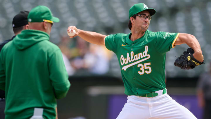 Aug 24, 2024; Oakland, California, USA; Oakland Athletics manager Mark Kotsay (7) watches starting pitcher Joe Boyle (35) throw a pitch after Boyle was struck by a batted ball against the Milwaukee Brewers during the second inning at Oakland-Alameda County Coliseum. Mandatory Credit: Robert Edwards-USA TODAY Sports