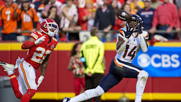 Nov 10, 2024; Kansas City, Missouri, USA; Denver Broncos wide receiver Courtland Sutton (14) catches a touchdown pass against Kansas City Chiefs cornerback Trent McDuffie (22) during the first half at GEHA Field at Arrowhead Stadium. Mandatory Credit: Jay Biggerstaff-Imagn Images