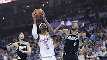 Mar 12, 2024; Oklahoma City, Oklahoma, USA; Oklahoma City Thunder guard Shai Gilgeous-Alexander (2) drives to the basket beside Indiana Pacers guard Tyrese Haliburton (0) during the first quarter at Paycom Center. Mandatory Credit: Alonzo Adams-Imagn Images