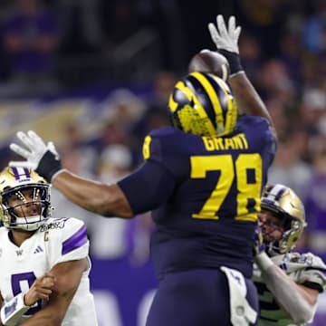 Jan 8, 2024; Houston, TX, USA; Michigan Wolverines defensive lineman Kenneth Grant (78) blocks a pass by Washington Huskies cornerback Thaddeus Dixon (9) during the third quarter in the 2024 College Football Playoff national championship game at NRG Stadium. 
