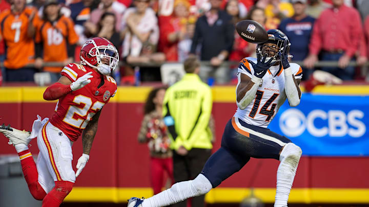 Nov 10, 2024; Kansas City, Missouri, USA; Denver Broncos wide receiver Courtland Sutton (14) catches a touchdown pass against Kansas City Chiefs cornerback Trent McDuffie (22) during the first half at GEHA Field at Arrowhead Stadium. Mandatory Credit: Jay Biggerstaff-Imagn Images