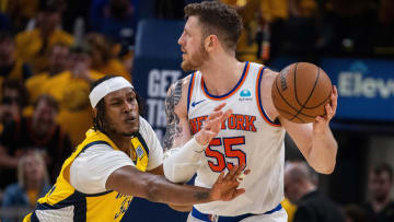 May 17, 2024; Indianapolis, Indiana, USA; New York Knicks center Isaiah Hartenstein (55) holds the ball while Indiana Pacers center Myles Turner (33) defends during game six of the second round for the 2024 NBA playoffs at Gainbridge Fieldhouse. Mandatory Credit: Trevor Ruszkowski-USA TODAY Sports