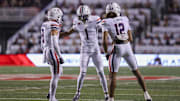 Sep 28, 2024; Salt Lake City, Utah, USA; Arizona Wildcats defensive back Gunner Maldonado (9), defensive back Tacario Davis (1) and defensive back Genesis Smith (12) celebrate a stop on fourth down against the Utah Utes during the first quarter at Rice-Eccles Stadium. 