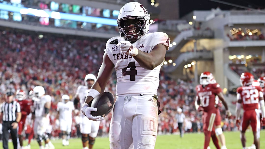 Oct 18, 2025; Fayetteville, Arkansas, USA; Texas A&M Aggies running back Rueben Owens II (4) celebrates after rushing for a touchdown in the fourth quarter against the Arkansas Razorbacks at Donald W. Reynolds Razorback Stadium. Mandatory Credit: Nelson Chenault-Imagn Images