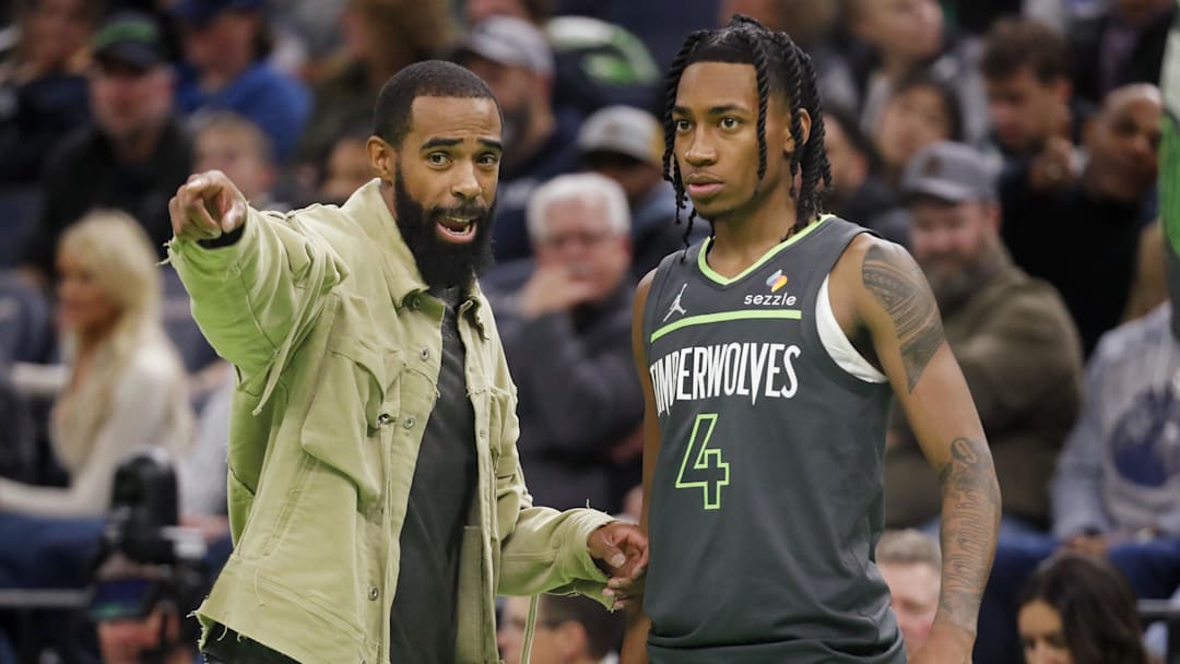 Nov 26, 2024; Minneapolis, Minnesota, USA; Minnesota Timberwolves guard Rob Dillingham (4) listens to guard Mike Conley (10) during a timeout in the fourth quarter against the Houston Rockets at Target Center. Mandatory Credit: Bruce Kluckhohn-Imagn Images