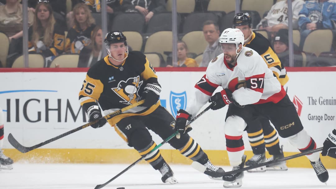 Mar 30, 2025; Pittsburgh, Pennsylvania, USA;  Ottawa Senators left wing David Perron (57) moves the puck against Pittsburgh Penguins center Noel Acciari (55) during the first period at PPG Paints Arena. Mandatory Credit: Charles LeClaire-Imagn Images