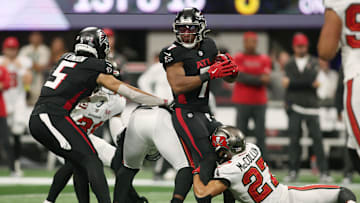 Sep 7, 2025; Atlanta, Georgia, USA; Tampa Bay Buccaneers cornerback Zyon McCollum (27) tackles Atlanta Falcons running back Bijan Robinson (7) during the first quarter at Mercedes-Benz Stadium. Mandatory Credit: Brett Davis-Imagn Images