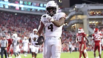 Oct 18, 2025; Fayetteville, Arkansas, USA; Texas A&M Aggies running back Rueben Owens II (4) celebrates after rushing for a touchdown in the fourth quarter against the Arkansas Razorbacks at Donald W. Reynolds Razorback Stadium. Mandatory Credit: Nelson Chenault-Imagn Images