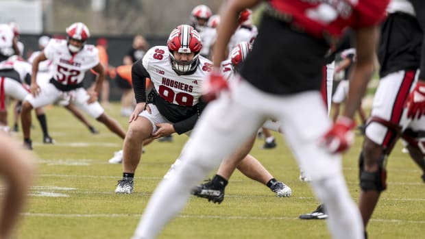 Defensive tackle James Carpenter stretches during an Indiana football practice on April 9, 2024.