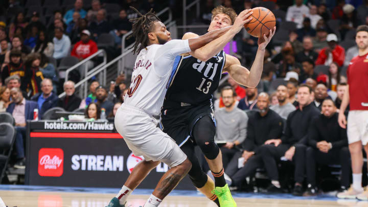 Mar 6, 2024; Atlanta, Georgia, USA; Cleveland Cavaliers guard Darius Garland (10) fouls Atlanta Hawks guard Bogdan Bogdanovic (13) in the second half at State Farm Arena. Mandatory Credit: Brett Davis-USA TODAY Sports