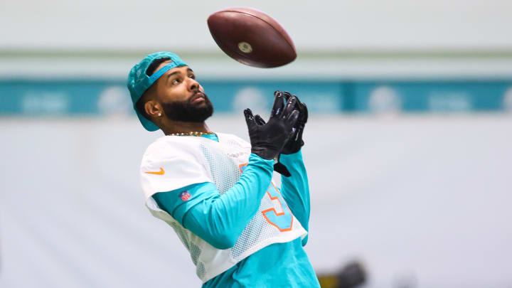Miami Dolphins wide receiver Odell Beckham Jr. plays with a football during mandatory minicamp at the Baptist Health Training Complex.