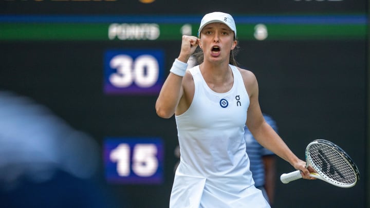 Jul 7, 2023; London, United Kingdom; Iga Swiatek (POL) reacts to a point during her match against Petra Martic (CRO) on day five of Wimbledon at the All England Lawn Tennis and Croquet Club.  Mandatory Credit: Susan Mullane-USA TODAY Sports 