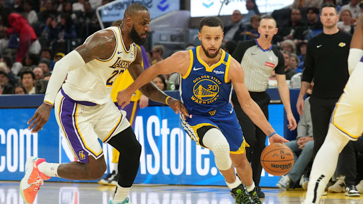 Golden State Warriors guard Stephen Curry (30) dribbles against Los Angeles Lakers forward LeBron James (left) during the third quarter at Chase Center. Mandatory Credit: Darren Yamashita-Imagn Images