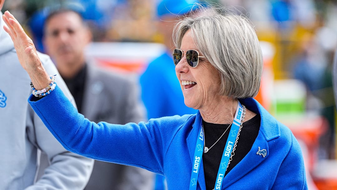 Detroit Lions owner Sheila Hamp waves at fans during warmups ahead of the season-opening game against Packers