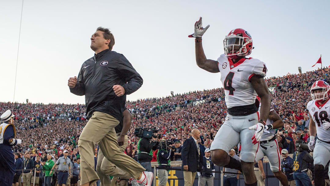 Sep 9, 2017; South Bend, IN, USA; Georgia Bulldogs head coach Kirby Smart and wide receiver Mecole Hardman (4) take the field for the game against the Notre Dame Fighting Irish at Notre Dame Stadium. Mandatory Credit: Matt Cashore-Imagn Images