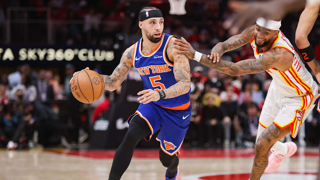 Knicks guard Jose Alvarado dribbles during a game.