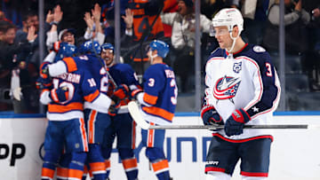 Blue Jackets center Charlie Coyle skates away as the Islanders celebrate their game winning goal. 