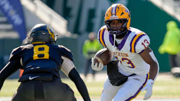 Dec 6, 2024; Birmingham, AL, USA; Jackson's Ezavier Crowell (13) tries to evade a tackle by Cherokee County's Tyson Wood (8) at Protective Stadium in the AHSAA 4A State Championship game.