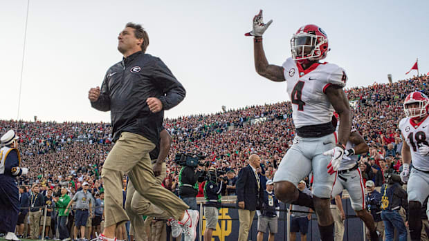 Kirby Smart leads the Georgia football team out at Notre Dame in 2017
