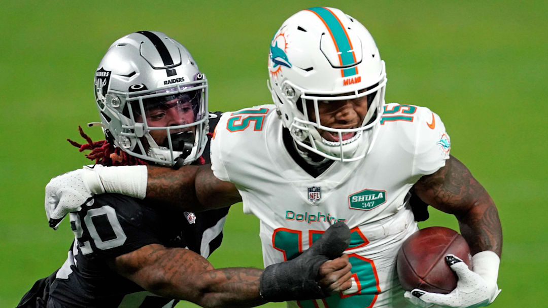 Dec 26, 2020; Paradise, Nevada, USA; Las Vegas Raiders cornerback Damon Arnette (20) tackles Miami Dolphins running back Lynn Bowden (15) during the first half at Allegiant Stadium. Mandatory Credit: Kirby Lee-Imagn Images Dec 26, 2020; Paradise, Nevada, USA; Las Vegas Raiders cornerback Damon Arnette (20) tackles Miami Dolphins running back Lynn Bowden (15) during the first half at Allegiant Stadium. Mandatory Credit: Kirby Lee-Imagn Images