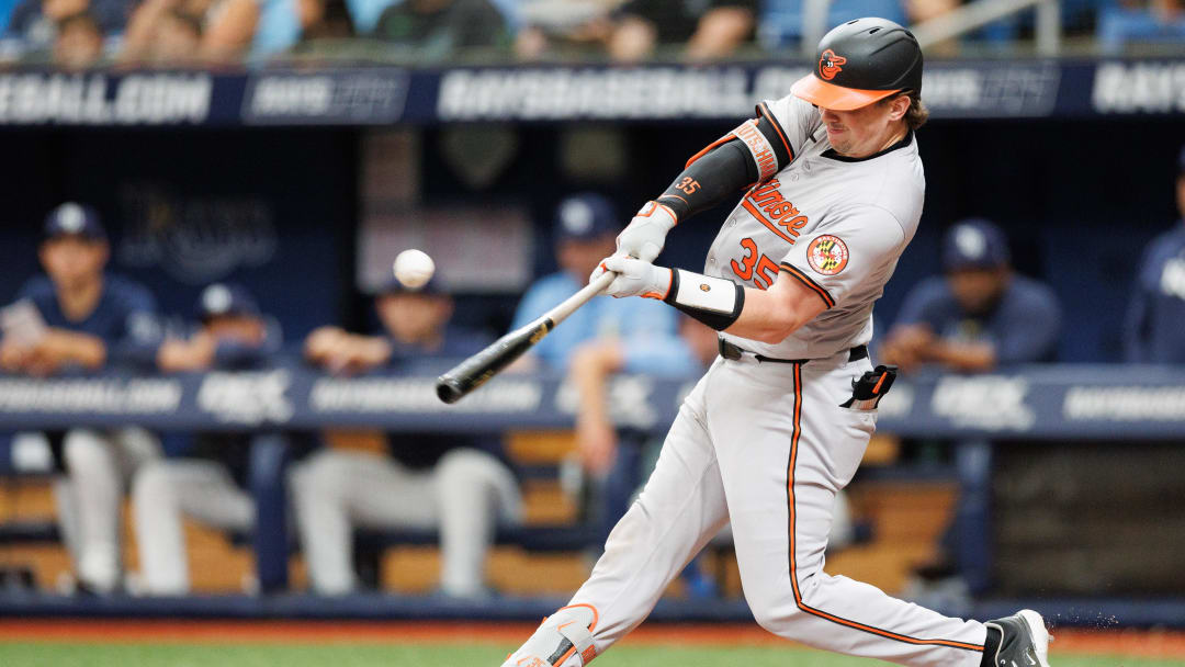 Jun 9, 2024; St. Petersburg, Florida, USA;  Baltimore Orioles catcher Adley Rutschman (35) hits an rbi single against the Tampa Bay Rays in the third inning at Tropicana Field. Mandatory Credit: Nathan Ray Seebeck-USA TODAY Sports