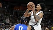 Jul 12, 2025; Las Vegas, NV, USA; San Antonio Spurs guard Dylan Harper (2) shoots against Dallas Mavericks guard Ryan Nembhard (9) in the first quarter of their game at Thomas & Mack Center.