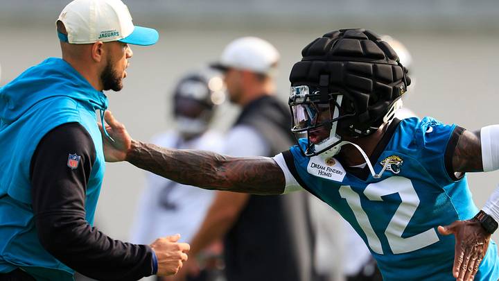 Jacksonville Jaguars wide receiver/cornerback Travis Hunter works on technique with defensive pass game coordinator Mathieu Araujo during the first day of training camp at the Miller Electric Center July 29 in Jacksonville, Florida.
