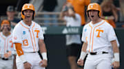 Tennessee's Reese Chapman (13) and Levi Clark (30) cheer for teammates Manny Marin (4) as he rounds the bases after hitting a home run at the NCAA college baseball Knoxville Regional final against Wake Forest on June 2, 2025, in Knoxville, Tenn.