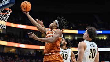 Texas guard Tre Johnson (20) drives past Vanderbilt guard Chris Manon (30) and forward Devin McGlockton (99) during the first half at Bridgestone Arena in Nashville, Tenn., Wednesday, March 12, 2025.