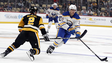 Sep 28, 2023; Pittsburgh, Pennsylvania, USA; Buffalo Sabres center Jiri Kulich (20) moves the puck against Pittsburgh Penguins defenseman Chad Ruhwedel (2) during the first period at PPG Paints Arena. Mandatory Credit: Charles LeClaire-Imagn Images